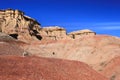 Cliffs with ovoo on red sands in Tsagaan Suvraga ÃÂ«ÃÂ white stupaÃÂ ÃÂ» area, Dundgovi Province, Mongolia. Vertical v